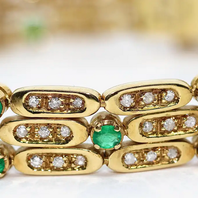 Damen Armband aus 18 Karat Gelbgold mit Diamanten und Smaragden