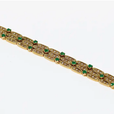Damen Armband aus 18 Karat Gelbgold mit Diamanten und Smaragden