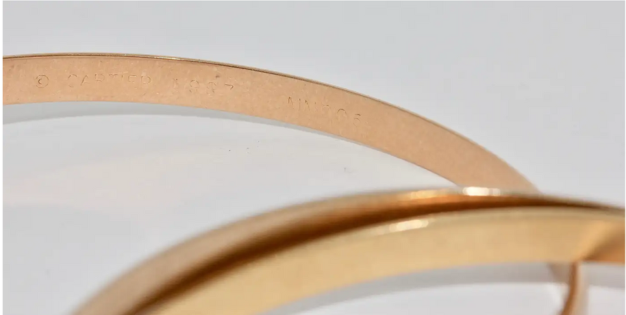Cartier „Trinity“ Armreif MD aus 18 Karat Gelb-, Weiß- und Roségold