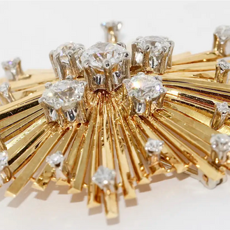 Brosche „Sternexplosion“ in 18 Karat Gelbgold mit Diamanten