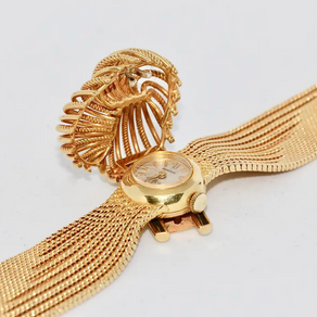 Universal Genève Damenarmbanduhr aus 18 Karat Gold mit Diamanten – multifunktional als Uhr & Brosche